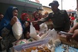 Sejumlah warga mengantri membeli beras maupun bahan pokok lain saat digelarnya pasar murah di kawasan Kalianak, Surabaya, Jawa Timur, Rabu (17/1). Pasar Murah yang tersebar di sejumlah lokasi digelar Pemkot Surabaya dengan menjual beras, minyak, gula, telur dan daging dengan harga normal itu guna meringankan beban ekonomi masyarakat. Antara jatim/Didik Suhartono/zk/18