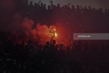 Suporter Persebaya Surabaya menyalakan flare ketika laga Persebaya Surabaya melawan Madura United pada babak penyisihan Grup C Piala Presiden 2018 di Gelora Bung Tomo, Surabaya, Jawa Timur, Minggu (28/1). Pertandingan tersebut memecahkan rekor penonton terbanyak pada laga Piala Presiden 2018 dengan jumlah sekitar 50 ribu penonton. Antara Jatim/Zabur Karuru/18