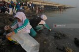 Sejumlah pelajar memunguti sampah yang berserakan di pinggiran pantai di dekat Jembatan Suramadu, Surabaya, Jawa Timur, Sabtu (24/2). Kegiatan yang diikuti ribuan pelajar, pegawai Pemkot Surabaya, TNI dan Polri itu dalam rangka Hari Peduli Sampah Nasional. Antara Jatim/Didik Suhartono/zk/18