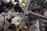 Relawan Siaga Bencana Berbasis Masyarakat (SIBAT) mengolah sampah plastik untuk kerajinan daur ulang di bank sampah Pusat Daur Ulang dan Kerajinan Masyarakat (PDUKM), Pondok Rajeg, Cibinong, Kabupaten Bogor, Jawa Barat, Jumat (23/2). Pusat Daur Ulang dan Kerajinan Masyarakat merupakan salah satu program Mitigasi Pengurangan Risiko Bencana Berbasis Masyarakat dan Adaptasi Perubahan Iklim, dan sebagai upaya membantu pemerintah dalam menangani pengolahan sampah serta mengubah sampah menjadi produk kerajinan yang memiliki nilai ekonomis. ANTARA JABAR/Yulius Satria Wijaya/agr/18.