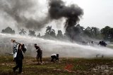 Sejumlah demonstran terkena semprota water canon saat simulasi pengamanan Pilkada serentak di Lapangan Tegar Beriman, Cibinong, Bogor, Jawa Barat, Selasa (13/2). Simulasi tersebut untuk melatih kesigapan petugas keamanan dalam rangka memberikan rasa aman saat Pilkada di Kabupaten Bogor dan Jawa Barat. ANTARA JABAR/Yulius Satria Wijaya