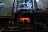 Petugas pemadam kebakaran memadamkan api yang membakar toko konveksi di Kawasan Pasar Baru, Jakarta, Selasa (27/2). Puluhan mobil pemadam kebakaran dikerahkan untuk memadamkan api yang membakar toko konveksi tersebut. 