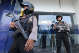 Polisi berjaga saat dilakukannya pemeriksaan mesin Anjungan Tunai Mandiri (ATM) di Bank Mandiri, Jalan Indrapura, Surabaya, Jawa Timur, Selasa (20/3). Peningkatan patroli dengan melakukan pemeriksaan mesin ATM di sejumlah bank yang dilakukan oleh Unit Raimas Sat Sabhara Polrestabes Surabaya itu untuk mengantisipasi kejahatan 'skimming'. Antara Jatim/Didik Suhartono/zk/18