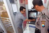 Petugas gabungan dari Polres Blitar Kota dan Kantor Cabang BRI memeriksa kondisi mesin Anjungan Tunai Mandiri (ATM) di salah satu kecamatan terpencil di Blitar, Jawa Timur, Kamis (22/3). Patroli gabungan tersebut bertujuan untuk mengantisipasi pencurian data nasabah perbankan melalui alat pemindai (Skimmer) yang dipasang di mesin-mesin ATM. Antara Jatim/Irfan Anshori/zk/18