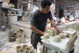 Pengrajin membuat keramik dengan bahan baku tanah liat kualitas ketiga di sebuah industri keramik rumah tangga di Malang, Jawa Timur,  Kamis (15/3). Pengrajin keramik setempat mengeluhkan adanya monopoli bahan baku berupa tanah liat sehingga mereka kesulitan mendapatkan bahan baku tanah liat kualitas pertama. Hal tersebut mengakibatkan para pengrajin keramik susah meningkatkan kualitas produknya dan kalah bersaing dengan produk keramik dari China. Antara Jatim/Ari Bowo Sucipto/zk/18.