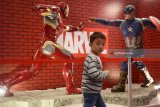 Pengunjung mengamati action figur superhero marvel Iron Man dan Captain America yang dipamerkan pada Experience Marvel Universe Exhibition di Surabaya, Jawa Timur, Rabu (28/3). Pameran tersebut dalam rangka menyambut film Avengers 'Infinity War' di Indonesia pada 25 April. Antara Jatim/Zabur Karuru/zk/18