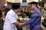 Gubernur Jawa Timur Soekarwo (kiri) berjabat tangan dengan Ketua Umum PP Muhammadiyah Haedar Nasir (kanan) disela-sela Rapat Kerja Nasional Majels Pembina Kesehatan Umum (MPKU) Pimpinan Pusat Muhammadiyah di Surabaya, Jawa Timur, Rabu (7/3). Rakernas MPKU PP Muhammadiyah  upaya untuk menata ulang dan menyusun dakwah bil hal Muhamadiyah di bidang layanan kesehatan. Antara Jatim/M Risyal Hidayat/zk/18