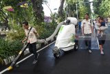 Petugas berusaha memungut sampah dengan menggunakan alat 'Tow Vacuum' di Hari Bebas Berkendara di Surabaya, Jawa Timur, Minggu (8/4). Alat tersebut merupakan bantuan bagi Dinas Kebersihan dan Ruang Terbuka Hijau kota Surabaya membersihkan sampah ketika berlangsung nya hari bebas berkendara. Antara Jatim/M Risyal Hidayat/zk/18