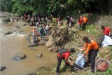 Sejumlah relawan memungut sampah di bantaran sungai Cisadane, Kelurahan Gunung Batu, Kota Bogor, Jawa Barat, Minggu (22/4/2018). Kegiatan 