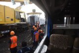 Petugas mengevakuasi gerbong KA Sancaka yang kecelakaan di Ngawi, Jawa Timur, Sabtu (7/4). Peristiwa tabrakan Kereta Sancaka dengan truk trailer tersebut menyebabkan satu orang meninggal yang merupakan masinis kereta itu. Antara Jatim/Zabur Karuru/18