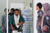 Sejumlah tenaga kerja yang dideportasi dari Malaysia meninggalkan ruangan Pos Pelayanan Penempatan dan Perlindungan Tenaga Kerja Indonesia (P4TKI) di pelabuhan Pelindo I kota Dumai, Dumai, Riau, Selasa (24/4/2018). Sebanyak 197 TKI bermasalah yang baru selesai menjalani masa hukuman beserta dua bayi dideportasi ke tanah air oleh Pemerintah Malaysia dari Melaka dan Port Dickson lewat Pelabuhan Dumai. (ANTARA FOTO/Aswaddy Hamid) 