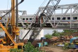 Pekerja menyiapkan pemasangan besi tiang penyangga pada jembatan kereta api yang menghubungkan Nganjuk dengan Jombang guna dibangun rel jalur ganda (double track) di Kertosono, Nganjuk, Jawa Timur, Selasa (3/4). Double track lintas selatan Jawa ditargetkan selesai pada tahun 2019. Antara jatim/Prasetia Fauzani/zk/18