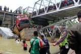 Sejumlah petugas mengevakuasi sepeda motor yang tercebur dalam kejadian jembatan Widang, di Kecamatan Widang, Tuban, Jawa Timur,  bagian barat yang ambrol sepanjang lebih dari 50 meter, Selasa (17/4) sekitar pukul 10.15 WIB. Dalam kejadian itu satu pengemudi truk ditemukan meninggal dunia, tiga korban selamat, serta tiga truk dan sebuah sepeda motor masuk ke Bengawan Solo. Antara jatim/Aguk Sudarmojo/zk/18.
