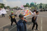 Sejumlah pedagang kartu telpon selular yang tergabung dalam Kesatuan Niaga Cellular Indonesia (KNCI) mengusung replika keranda mayat saat berunjuk rasa di depan Gedung DPRD Jatim, Surabaya, Jawa Timur, Senin (2/4). Pengunjuk rasa menolak aturan pembatasan tiga kartu SIM untuk satu Nomor Induk Kependudukan (NIK) yang dianggap merugikan mereka. Antara jatim/Didik Suhartono/zk/18