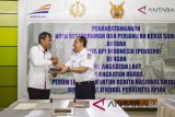 Direktur Utama Perum LKBN Antara Meidyatama Suryodiningrat (kiri) menerima cenderamata dari Direktur SDM dan Umum PT KAI Ruli Adi (kanan) usai menandatangani nota kesepahaman dan perjanjian kerja sama di Stasiun Gambir, Jakarta, Jumat (13/4). Kerja sama tersebut tentang pemanfaatan aset dalam rangka sinergi Badan Usaha Milik Negara yang bertujuan untuk memberikan pelayanan yang terbaik. ANTARA FOTO/Galih Pradipta/wdy/2018.