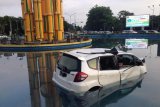 Sebuah mobil Honda Jazz dengan nopol KB 1068 SN berada di dalam kolam air mancur Tugu Digulis, Pontianak, Kalbar, Jumat (6/4). Mobil tersebut melompat masuk ke kolam saat mengalami kecelakaan tunggal yang terjadi pada Jumat (6/4) dini hari pukul 02.30 wib.  ANTARA/Jessica Helena Wuysang/18