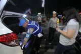 Polisi memeriksa isi barang bawaan pengguna mobil yang terjaring razia cipta kondisi di Jalan Darmo, Surabaya, Jawa Timur, Sabtu (26/5) malam. Operasi yang digelar Polrestabes Surabaya itu memeriksa kelengkapan surat kendaraan bermotor dan barang bawaannya guna mengantisipasi peredaran minuman keras, narkoba, senjata tajam atau bahan-bahan berbahaya serta untuk memberikan rasa aman kepada masyarakat. Antara Jatim/Didik Suhartono/zk/18