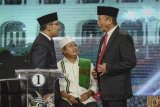 Pasangan calon Gubernur dan Wakil Gubernur Jawa Barat nomor urut satu Ridwan Kamil (kiri) dan Uu Ruzhanul Ulum (tengah) berbincang dengan Calon Gubernur Jawa Barat nomor dua TB Hasanuddin saat mengikuti debat publik ketiga Pilgub Jabar di Bandung, Jawa Barat, Jumat (22/6) malam. Debat ketiga Pilgub Jabar yang merupakan debat terakhir tersebut bertemakan 