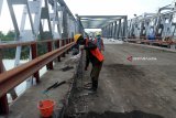 Sejumlah pekerja bekerja menyelesaikan pekerjaan perbaikan jembatan Widang, di Kecamatan Widang, Tuban, Jawa Timur, yang ambruk, Kamis (31/5). Balai Besar Pelaksanaan Jalan Nasional (BBPJN) VIII Surabaya akan memfungsikan jembatan Widang bagian timur itu pada 3 Juni, namun hanya untuk kendaraan ringan. Antara jatim/Aguk Sudarmojo/zk/18.
