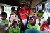 Direktur Sido Muncul Irwan Hidayat (tengah) menyapa pedagang jamu dan keluarganya yang menjadi peserta mudik gratis Sido Muncul ke-29 di Museum Purna Bhakti Pertiwi, Taman Mini Indonesia Indah (TMII), Jakarta, Sabtu (9/6/2018). Mudik gratis yang diikuti 13 ribu pedagang jamu di Jakarta dan sekitarnya itu menggunakan 220 bus AC. (ANTARA/Saptono)