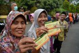 Warga menunjukkan kupon untuk pengambilan zakat fitrah berupa beras di pendopo Sidoarjo, Jawa Timur, Rabu (13/6). Sekitar 5.000 paket zakat fitrah dari pegawai kabupaten Sidoarjo tersebut diberikan kepada masyarakat yang membutuhkan menjelang hari raya Idulfitri. Antara Jatim/Umarul Faruq/zk/18