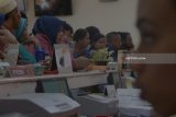 Warga mengantri penarikan dana kiriman dari luar negeri (remiten) di kantor PT Pos Indonesia Cabang Tulungagung, Tulungagung, Jawa Timur, Rabu (12/6). Sejak dua pekan menjelang Lebaran, transaksi remiten di daerah ini meningkat 25 persen, dari biasanya 250-300-an transaksi kini menjadi 300-400 transaksi per hari dengan besaran nominal penarikan rata-rata Rp1 juta - Rp2 juta per orang, Antara Jatim/Destyan Sujarwoko/zk/18