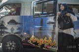 Warga membuka turun dari Angkot eksekutif Angkutan Keliling Kota Bandung (Angklung) jurusan Ciwastra-Cijerah, Bandung, Jawa Barat, Kamis (5/7). Angkot eksekutif yang semula memiliki fasilitas AC, perpustakaan dan televisi dengan tarif dekat-jauh Rp. 7000 tersebut perlahan mulai mengurangi penggunaan fasilitas serta mengubah tarif kembali normal sesuai jarak tempuh akibat semakin sedikitnya warga yang menggunakan fasilitas angkot angklung maupun angkot konvensional. ANTARA JABAR/Novrian Arbi/agr/18
