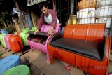 Pekerja menyelesaikan pembuatan kursi dari drum bekas di industri kecil Ali Kreatif, Parung, Kabupaten Bogor, Jawa Barat, Selasa (10/7). mebel tersebut dijual dengan harga Rp1,5 juta - Rp 3,5 juta per set dan dipasarkan di wilayah Jabodetabek. ANTARA JABAR/Yulius Satria Wijaya/agr/18.