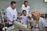 Menteri BUMN Rini Soemarno (kedua kanan) didampingi Direktur Utama PT PNM Arief Mulyadi (kiri) Direktur Utama PT Bank Rakyat Indonesia (BRI) Suprajarto (ketiga kiri) meninjau peserta pelatihan jahit menjahit pada acara sinergi Usaha Nasabah Mekar membina ekonomi usaha keluarga sejahtera di Aula Desa Cikupa, Kabupaten Tasikmalaya, Jawa Barat, Kamis (12/7). PNM melalui Program Pengembangan Kapasitas Usaha atau PKU memberikan pelatihan menjahit kepada 200 nasabah Mekar untuk memberikan pengetahuan dan keterampilan baru dalam menjahit, dengan jumlah nasbah yang tercatat di Jabar mencapai 695.243 mayoritas usaha pertanian dan perdagangan. ANTARA JABAR/Adeng Bustomi/agr/18 