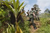 Komandan Pusat Teritorial Mabes TNI Angkatan Darat (Danpusterad Mabesad) Mayjen TNI Hartomo (kiri) menuruni bukit saat meninjau kegiatan TNI Manunggal Membangun Desa (TMMD) di Desa Bodag, Kecamatan Kare, Kabupaten Madiun, Jawa Timur, Kamis (19/7). Mayjen TNI Hartomo meninjau sejumlah kegiatan TMMD, antara lain pembangunan Rumah Tidak Layak Huni (RTLH), pembuatan jalan rabat beton menuju objek wisata Selo Gedong di lereng Gunung Wilis, pengobatan gratis dan wawasan kebangsaan. Antara Jatim/Siswowidodo/mas/18.