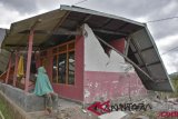 Warga berada di rumahnya yang rubuh akibat gempa di Desa Sembalun Bumbung, Kecamatan Sembalun, Selong, Lombok Timur, NTB, Minggu (29/72018). Gempa bumi berkekuatan 6,4 pada Skala Richter (SR) mengguncang wilayah Lombok, Nusa Tenggara Barat, pada Minggu (29/7) pukul 06.47 Wita. Data sementara Badan Nasional Penanggulangan Bencana (BNPB) mencatat, gempa mengakibatkan tiga orang meninggal dunia, 12 warga luka-luka, puluhan rumah dan bangunan lainnya rusak (ANTARA FOTO/Ahmad Subaidi)
