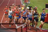 Sejumlah atlet berusaha saling mendahului usai start pada lomba marathon Asian Games 2018 di Stadio Utama Gelora Bung Karno, Senayan, Jakarta, Sabtu (25/8/2018). (ANTARA FOTO/INASGOC/Boy T. Harjanto)