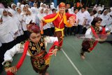 Mahasiswa asing asal Lituania yang mengikuti program pertukaran pelajar, Gabija Bargailaite (tengah) belajar Tari Remo di halaman SMP Muhammadiyah 4, Surabaya, Jawa Timur, Senin (6/8). Kegiatan yang diprakarsai oleh Association Internationale des Etudiants en Sciences Economiques et Commerciales (AIESEC) tersebut guna mengenalkan kebudayaan Indonesia serta berbagi ilmu dan pengalaman. Antara jatim/Moch Asim/18