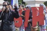 Sejumlah aktivis dan penggiat HAM melakukan aksi unjuk rasa di depan kantor Kemenkopohukam, Jakarta, Kamis (2/8/2018). Mereka menuntut pemerintah menuntaskan kasus-kasus pelanggaran HAM berat yang terjadi pada masa lalu. (ANTARA /Hafidz Mubarak A) 
