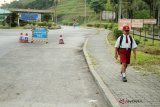 Nursaka (8 tahun), Warga Negara Indonesia yang bermukim di Tebedu, Sarawak, Malaysia berjalan kaki menuju Pos Lintas Batas Negara (PLBN) Entikong di Kabupaten Sanggau, Kalbar, Kamis (13/9). Nursaka (8 tahun) setiap hari melintasi dua negara dari Malaysia menuju Indonesia melalui PLBN Entikong untuk bersekolah di SDN 03 Sontas Entikong. ANTARA FOTO/HS Putra/jhw/18