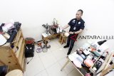 Personil Satuan Narkoba Polres Metro Jakarat Barat menunjukkan barang bukti di rumah produksi ekstasi di Perumahan Sentra Pondok Rajeg, Cibinong, Bogor, Jawa Barat, Senin (24/9). Satuan Reserse Narkoba Polres Metro Jakarta Barat menggerebek pabrik ekstasi jenis baru dan mengamankan tiga orang tersangka dengan barang bukti 3000 butir ekstasi beserta alat dan bahan pembuatnya. ANTARA JABAR/Yulius Satria Wijaya/agr/18.