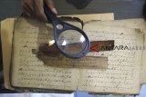 Petugas memeriksa naskah kuno di Museum Bandar Cimanuk (MBC), Indramayu, Jawa Barat, Minggu (23/9). Museum Bandar Cimanuk bekerja sama dengan Digital Repository on Endangered and Affected Manuscripts in Southeast Asia (DREAMSEA) melakukan inventarisasi dan digitalisasi naskah kuno yang ada di museum di Indramayu. ANTARA JABAR/Dedhez Anggara/agr/18.