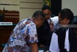 Terdakwa Bupati nonaktif Mojokerto Mustofa Kamal Pasa (kiri) berkonsultasi dengan pengacaranya seusai menjalani sidang perdana di Pengadilan Tindak Pidana Korupsi (Tipikor) Juanda, Sidoarjo, Jawa Timur, Jumat (14/9). Mustofa Kamal Pasa menjadi terdakwa terkait kasus menerima suap atas pengurusan izin prinsip pemanfaatan ruang (IPPR) dan Izin Mendirikan Bangunan (IMB) atas Pembangunan Menara Telekomunikasi di Kabupaten Mojokerto tahun 2015 sebesar Rp2,7 miliar. Antara Jatim/Umarul Faruq/mas/18.