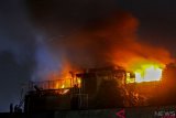 Petugas Pemadam Kebakaran berusaha memadamkan api yang membakar bangunan bagian atas hotel Linda di Pekanbaru, Riau, Kamis (27/9/2018) dini hari. Tidak ada korban jiwa dalam peristiwa itu dan pihak Kepolisian masih melakukan penyelidikan untuk mengetahui penyebab terjadinya kebakaran.  (ANTARA FOTO/Rony Muharrman)