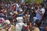 Bupati Lombok Utara Najmul Akhyar (kanan) menemui warga korban gempa yang berunjuk rasa di kantor Bupati Lombok Utara di Tanjung, Lombok Utara, NTB, Rabu (26/9). Ratusan warga korban gempa Lombok Utara tersebut menuntut janji pemerintah di antaranya segera merealisasikan bantuan uang untuk pembangunan rumah, mempermudah proses administrasi serta segera merealisasikan uang Jaminan Hidup (Jadup) yang dijanjikan pemerintah sebesar Rp10.000 per hari per jiwa bagi korban gempa yang hingga saat ini masih tinggal di tenda pengungsian. ANTARA FOTO/Ahmad Subaidi/wdy/2018