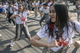 Sejumlah penari membawakan tarian kolaborasi modern dan tradisional dalam Flashmob Indonesia Menari 2018 pada Car Free Day, di Dago, Bandung, Jawa Barat, Minggu (14/10). Acara tersebut merupakan rangkaian awal dan pengenalan kepada masyarakat tentang gelaran Indonesia Menari 2018 yang dilaksanakan serentak di empat kota yakni Bandung, Jakarta, Semarang dan Solo pada 11 November mendatang. ANTARA JABAR/Novrian Arbi/agr/18