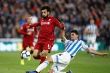 Pemain Liverpool Mohamed Salah (kiri) berebut bola dengan pemain ?Huddersfield Town Christopher Schindler pada pertandingan liga inggris di stadion John Smith, Sabtu (20/10/2018). LIverpool menang dengan skor 0-1. ANTARA FOTO/Reuters/Carl Recine/pras.