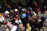 Warga mengantre untuk mendapatkan air bersih saat digelar kegiatan Jurnalis Magetan Peduli Bencana Kekeringan di Desa Kuwon, Kecamatan Karas, Kabupaten Magetan, Jawa Timur, Jumat (26/10/2018). Sejumlah wartawan yang bekerja di wilayah Kabupaten Magetan menggelar kegiatan sosial bekerja sama dengan Badan Penanggulangan Bencana Daerah (BPBD), PMI dan PDAM setempat dengan mendistribusikan 20.000 liter air bersih ke desa tersebut guna membantu memenuhi kebutuhan air bersih bagi 2.000 jiwa warga terdampak krisis air bersih akibat kemarau. Antara Jatim/Siswowidodo/ZK