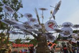 Warga berswafoto di dekat pohon payung geulis tradisional jelang Tasikmalaya Oktober Festival di Taman Kota Tasikmalaya, Jawa Barat, Jumat (12/10). Tasikmalaya Oktober Festival yang digelar 13-16 Oktober 2018 merupakan ajang gabungan yang menjadi agenda tahunan dengan menampilkan Pameran Tasik Kreatif, Food Culinary, Muslim Fashion Show, Gelar Budaya, Seminar Potensi Unggulan, Rakor Komwil III Apkesi, untuk menarik wisata lokal dan mancanegara. ANTARA JABAR/Adeng Bustomi/agr/18