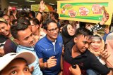 Calon Wakil Presiden Sandiaga Uno (tengah) menyapa pengunjung dan pedagang ketika berkunjung ke Pusat Grosir Surabaya (PGS), Surabaya, Jawa TImur, Minggu (21/10/2018). Kunjungan tersebut dalam rangka meyapa para pedagang sekaligus meninjau perekonomian di pusat perbelanjaan itu. Antara Jatim/Zabur Karuru