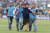 Petugas keamanan pertandingan menggiring oknum suporter Arema FC (Aremania) yang memasuki lapangan saat istirahat babak pertama dalam pertandingan Liga I GOJEK antara Arema melawan Persebaya Surabaya di Stadion Kanjuruhan, Malang, Jawa Timur, Sabtu (6/10) Dalam pertandingan tersebut Arema FC mengalahkan Persebaya dengan skor akhir 1-0. Antara Jatim/Ari Bowo Sucipto/mas/18.