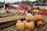 Buruh memindahkan jerigen kosong dari kapal antar pulau saat merapat di dermaga Krueng Aceh, Lampulo, Banda Aceh, Kamis (15/11/2018). Sejumlah nelayan di pulau Beras dan Pulau Nasi dalam kecamatan Pulau Aceh, Kabupaten Aceh Besar tersebut, sejak sepekan terakhir mengalami kesulitan memperoleh bahan bakar solar yang mereka pasok dari daratan Banda Aceh, sehingga aktivitas melaut tidak berjalan normal. (Antara Aceh/Ampelsa)