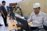 Polisi berpakaian ala tempo dulu melayani pemohon Surat Izin Mengemudi (SIM) di Polresta Kediri, Jawa Timur, Sabtu (10/11/18). Pelayanan bertema Hari Pahlawan tersebut guna mengenang jasa pahlawan pejuang kemerdekaan Indonesia. Antara Jatim/Prasetia Fauzani/ZK.