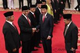 Presiden Joko Widodo (kedua kanan) menyalami Gubernur DKI Jakarta Anies Baswedan disaksikan Wakil Presiden Jusuf Kalla (kanan) seusai memberikan tanda jasa kepada ahli waris saat penganugerahan gelar pahlawan nasional di Istana Negara, Jakarta, Kakis (8/11/2018). Presiden menganugerahkan gelar pahlawan nasional kepada enam tokoh yaitu Abdurrahman Baswedan dari DI Yogyakarta, Agung Hajjah Andi Depu dari Sulawesi Barat, Depati Amir dari Bangka Belitung, Kasman Singodimedjo dari Jawa Tengah, Pangeran Muhammad Noor dari Kalimantan Selatan dan Brigjen K.H Syam'un dari Banten. ANTARA FOTO/Wahyu Putro A/ama.