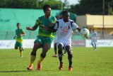 Pesepak bola Madura United (MU) Engelberd Sani  (kanan) berebut bola dengan pesepak bola Madura FC (MFC) Muhamad Choirul Rifan  (kiri) dalam penyisihan Piala Indonesia di Stadion A. Yani, Sumenep, Jawa Timur, Kamis (6/12/2018). MU mengalahkan MFC dengan skor 4-1. Antara Jatim/Saiful Bahri/ZK.